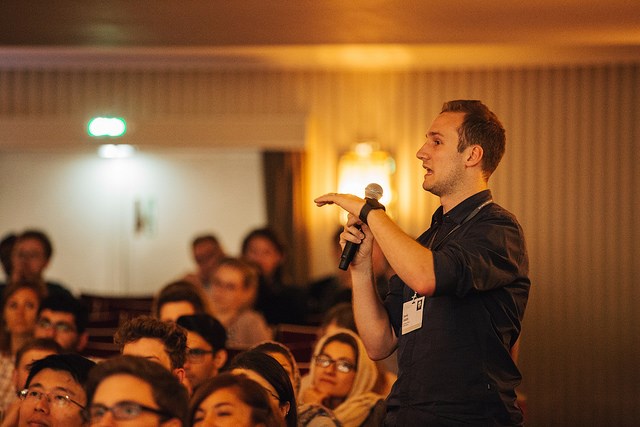 Young scientist asking questions at the panel discussion "Current and Future Game Changers in Chemistry"