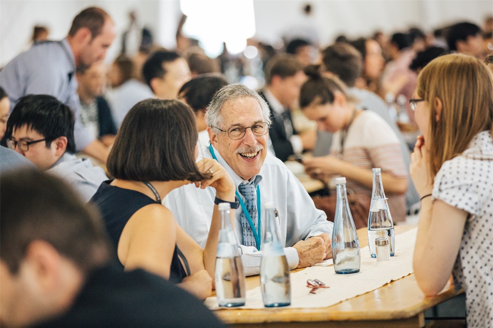 Peter Diamond with young scientists at a social event