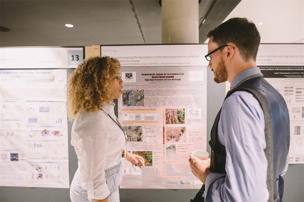 Young scientists presenting their research at the Poster Session