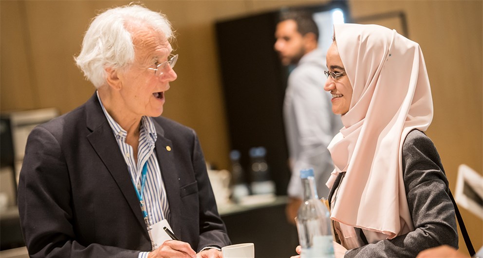 Gérard Mourou in discussion with a young scientist