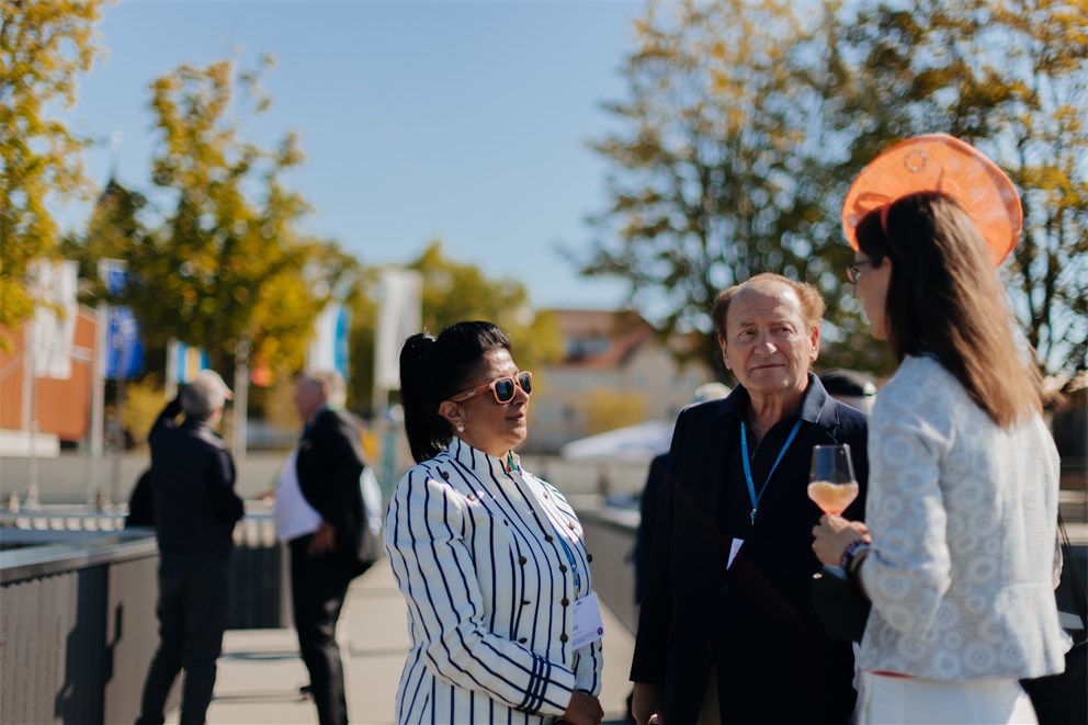 Countess Bettina Bernadotte conversing with Robert C. Merton and his wife.