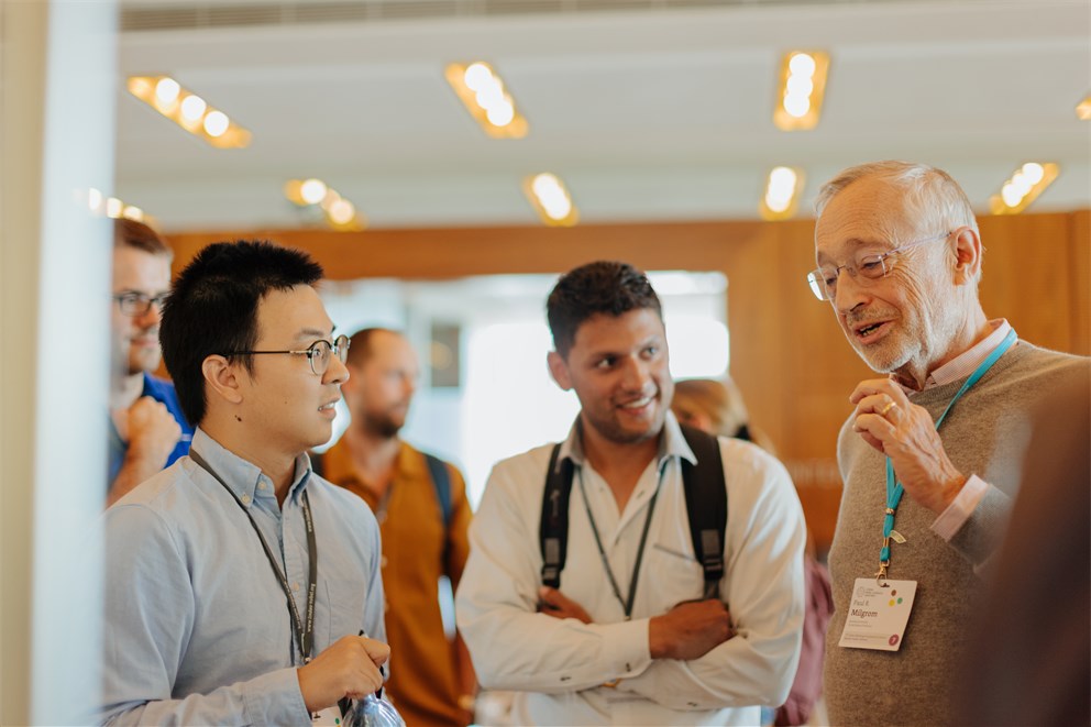 Paul R. Milgrom talking with Young Economists. 