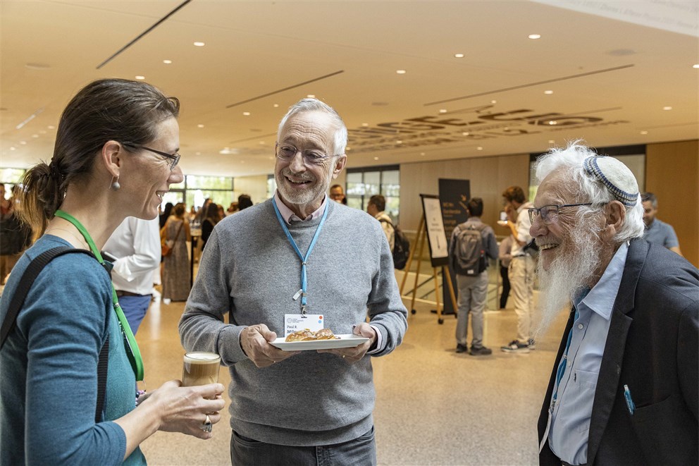 Paul R. Milgrom and Robert J. Aumann conversing with Countess Bettina Bernadotte.